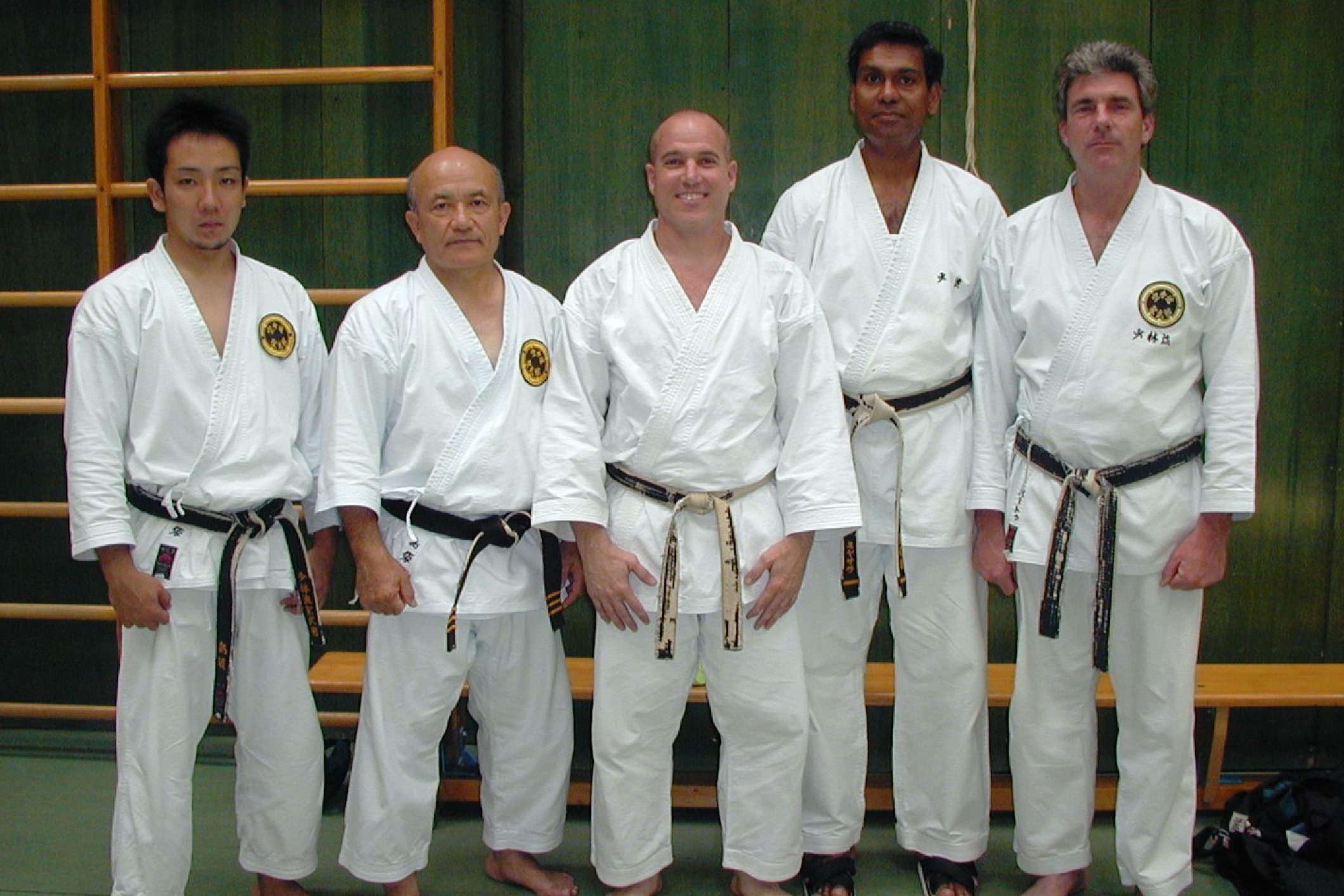 Five men in karate gis and belts