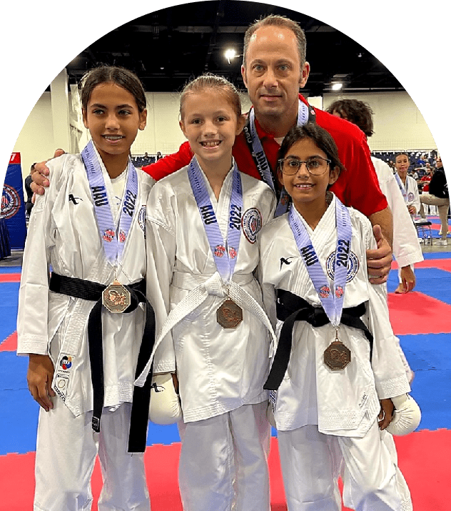 Karate team with medals and coach