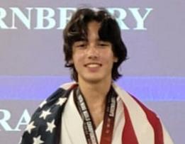 Smiling athlete wrapped in American flag