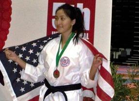 Athlete celebrating with flag and award