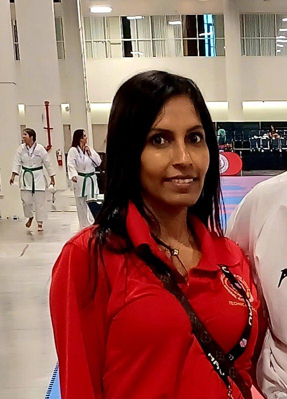 Woman in red shirt at indoor event
