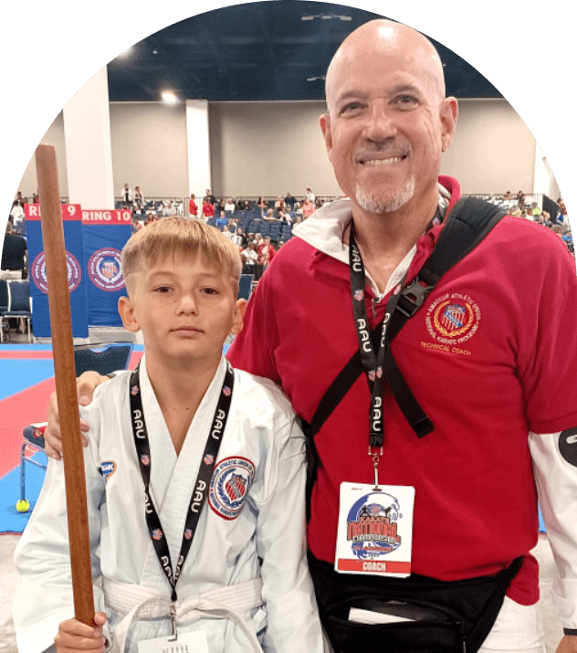 Martial arts coach with young student