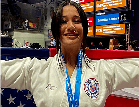 Martial artist with medal smiling proudly