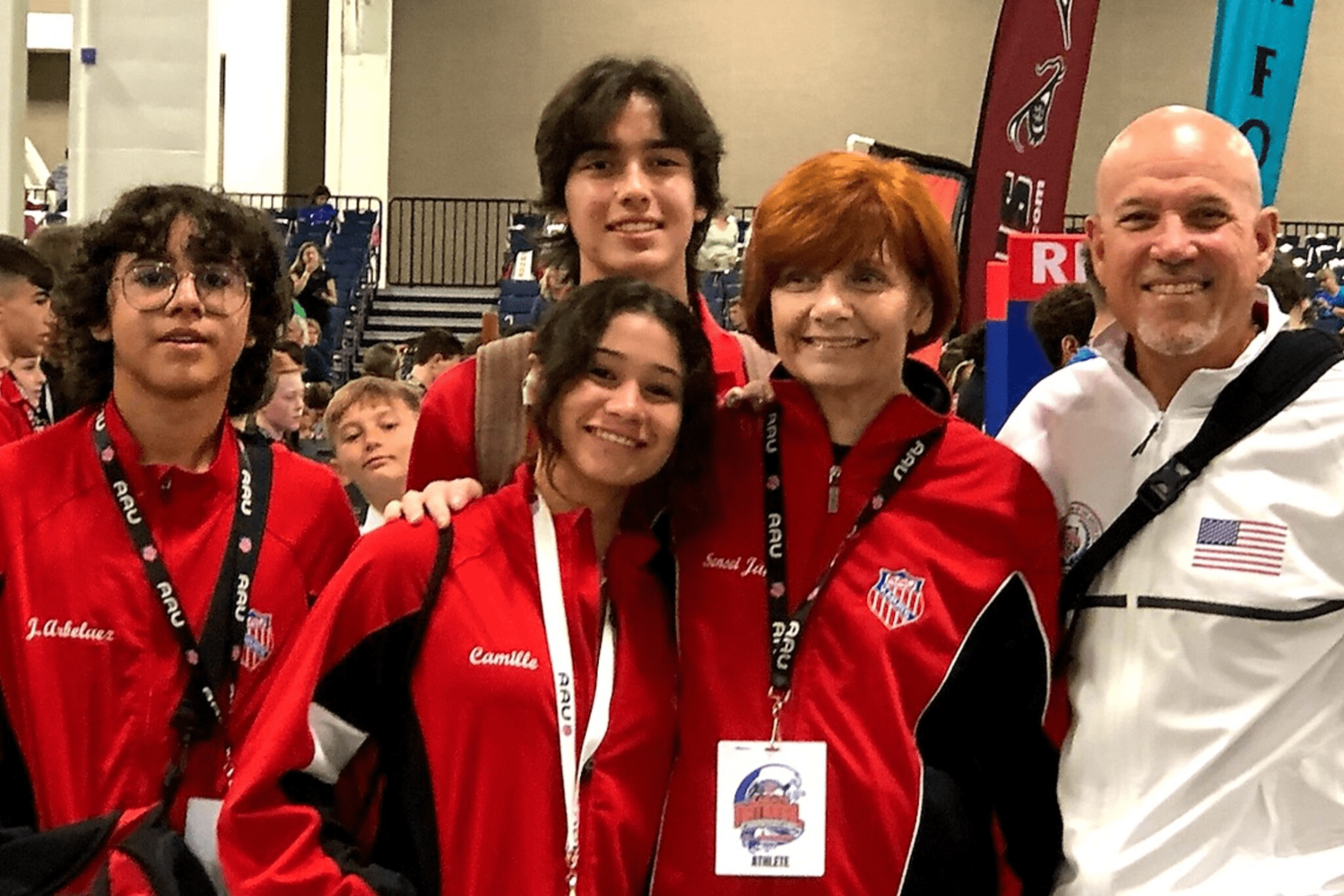 Smiling team wearing matching red uniforms