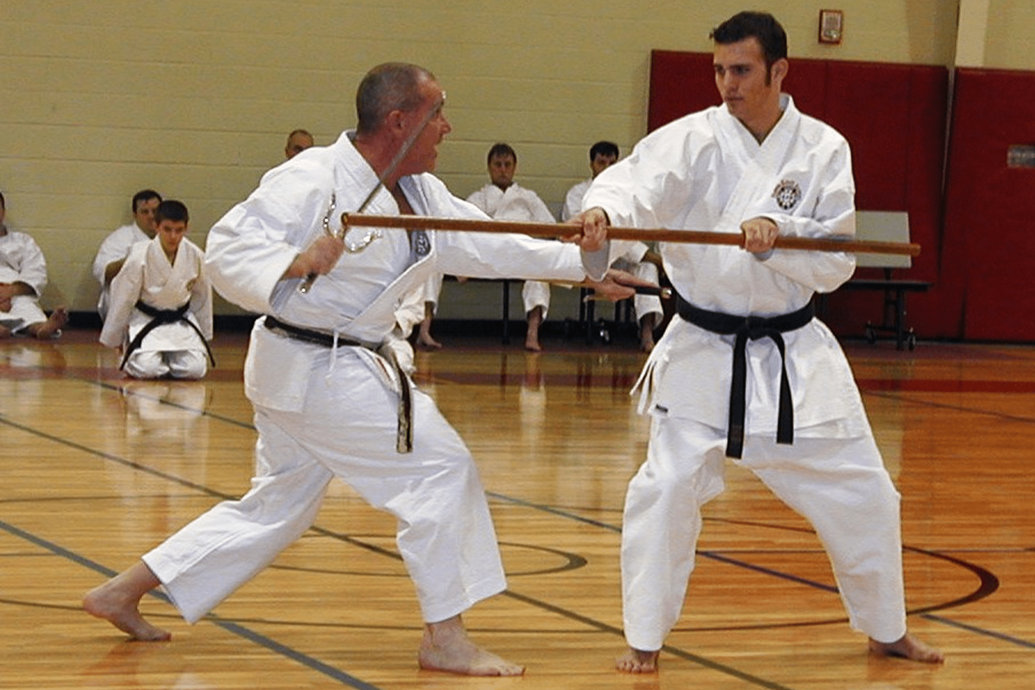 Martial artists practicing with bo staffs