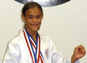 Young athlete with medals smiling