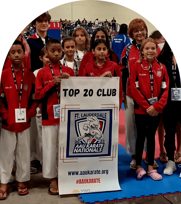 Karate team with Top 20 Club banner
