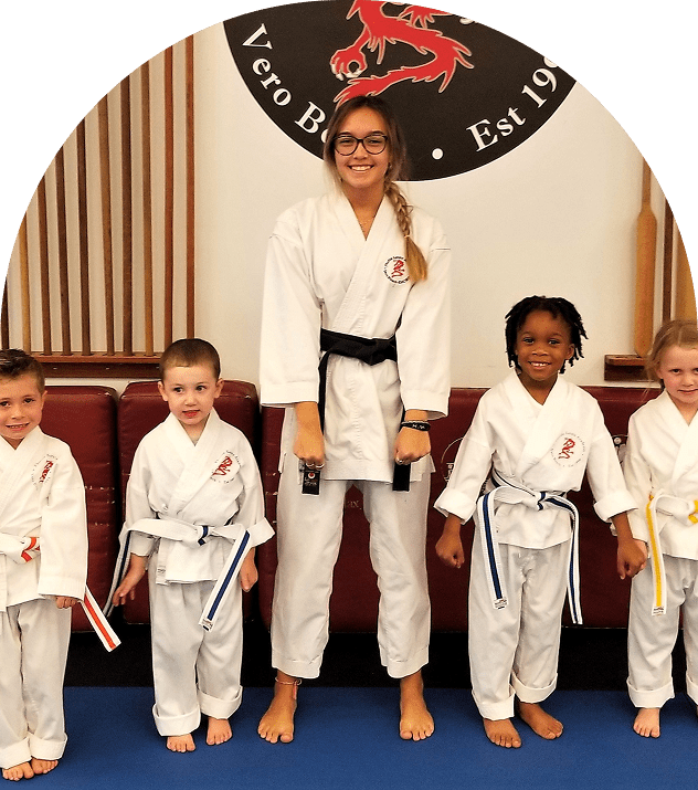 Karate instructor with young students smiling