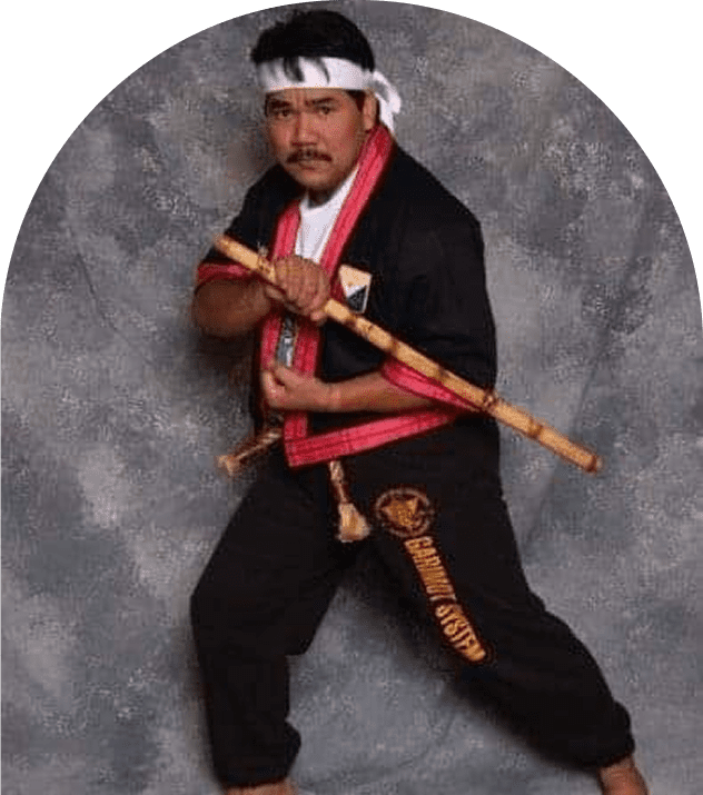 Man in martial arts uniform, holding stick