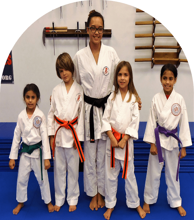 Karate instructor with young students in dojo