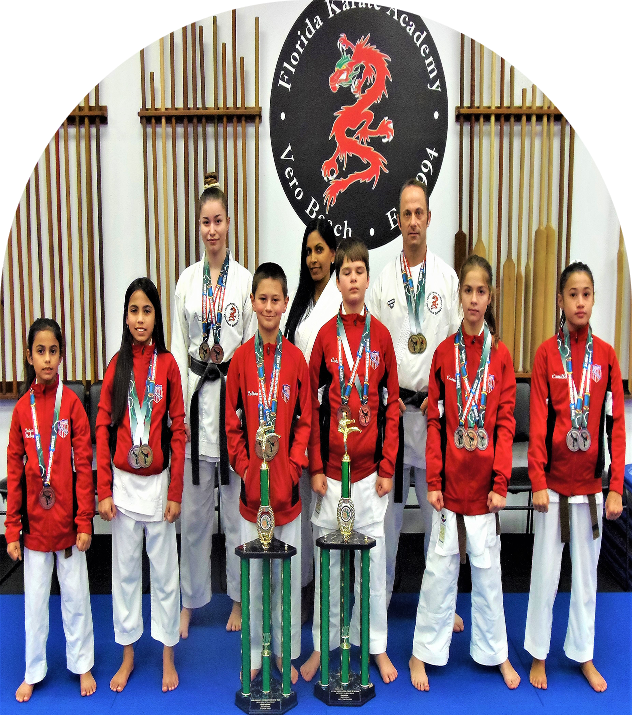 Martial arts team posing with medals