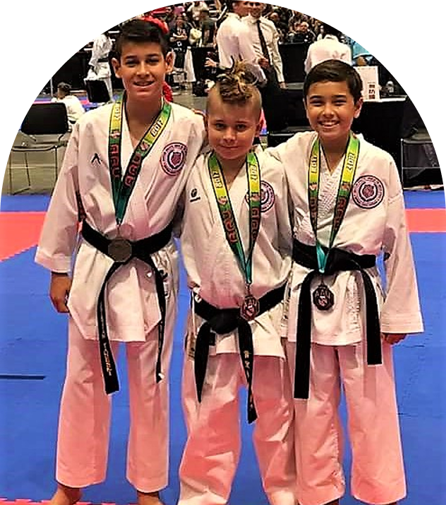 Karate kids smiling with awards