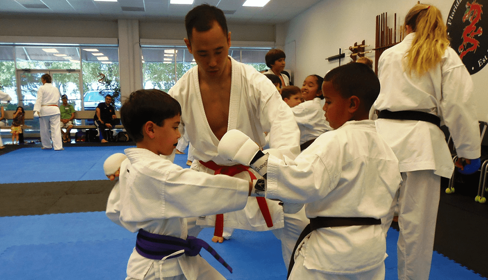 Kids practicing karate with instructor