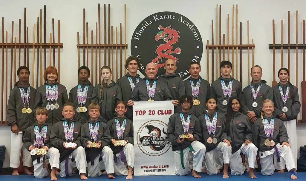 Martial artists with awards and banner